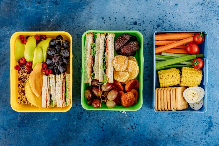 “Lunchbox with fruit, sandwich, and crackers for school.”